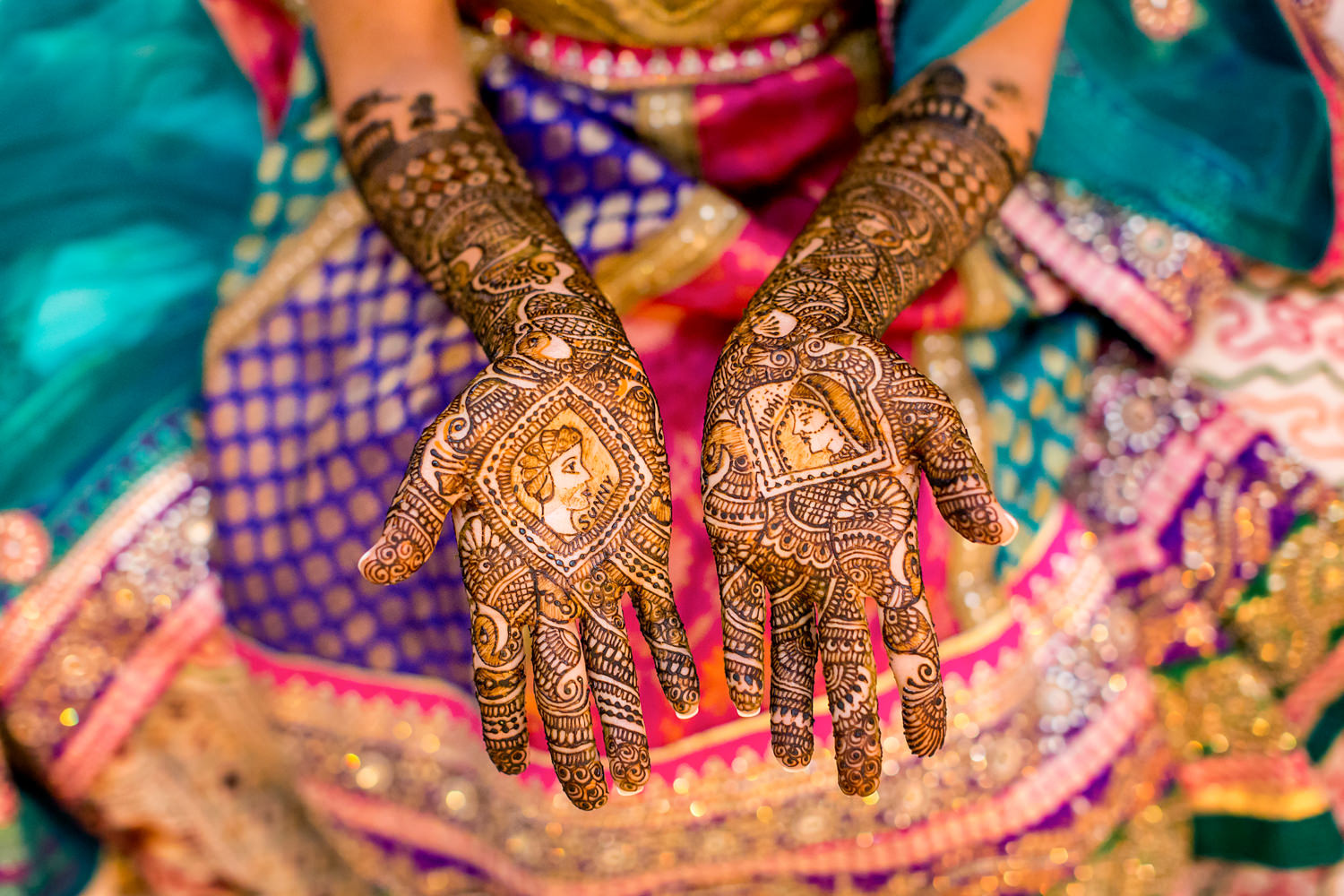 This Indian bride requested cameos of her and her fiancé on her hands, the artwork is so detailed and realistic, she has on a colorful dress and all you see is her hands and her lap, Procopio Photography, best top Washington DC photographer, best top Maryland photographer, best top Virginia photographer, best top DMV photographer, best top wedding photographer, best top commercial photographer, best top portrait photographer, best top boudoir photographer, modern fine art portraits, dramatic, unique, different, bold, editorial, photojournalism, award winning photographer, published photographer, memorable images, be different, stand out