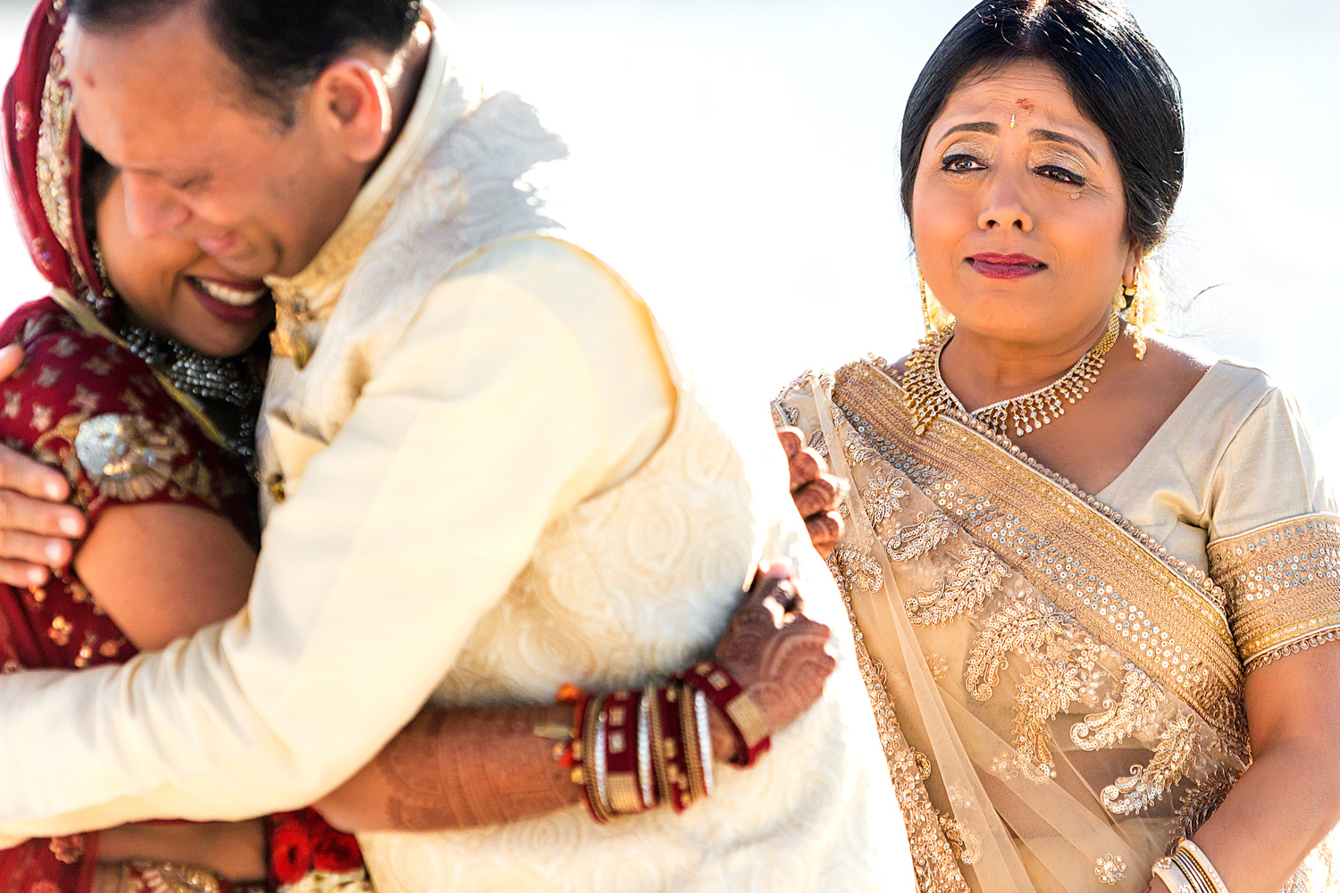 This was an Indian Hindu wedding on the Eastern Shore, This was the parents' giving away their daughter in an emotional embrace, Dad is hugging his daughter and you can see a tear streaming down her mother's face in the background, Procopio Photography, best top Washington DC photographer, best top Maryland photographer, best top Virginia photographer, best top DMV photographer, best top wedding photographer, best top commercial photographer, best top portrait photographer, best top boudoir photographer, modern fine art portraits, dramatic, unique, different, bold, editorial, photojournalism, award winning photographer, published photographer, memorable images, be different, stand out