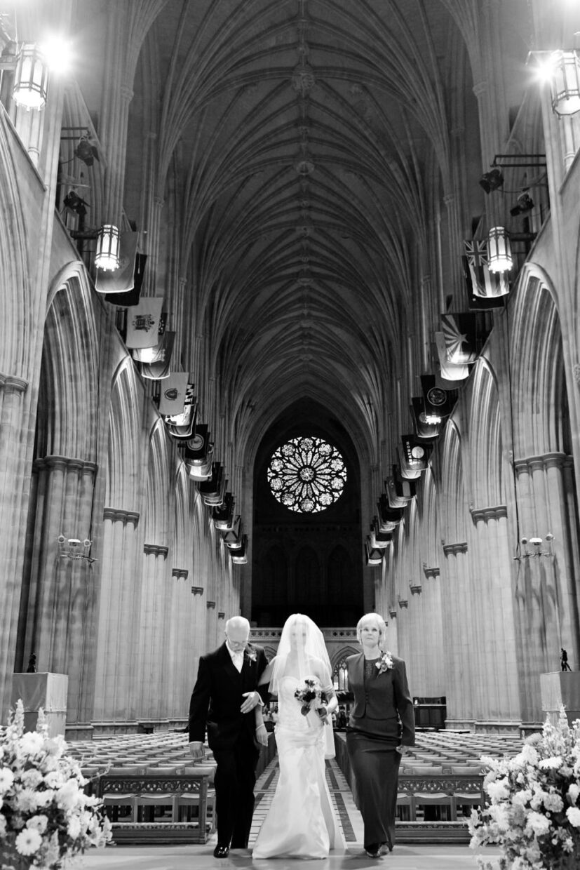 This Washington National Cathedral, Washington DC wedding was stunning, the sheer size of the National Cathedral is just regal, this black and white photo is of the bride arm in arm with her mother and her father as they process up the aisle, ceremony, Procopio Photography, best top Washington DC photographer, best top Maryland photographer, best top Virginia photographer, best top DMV photographer, best top wedding photographer, best top commercial photographer, best top portrait photographer, best top boudoir photographer, modern fine art portraits, dramatic, unique, different, bold, editorial, photojournalism, award winning photographer, published photographer, memorable images, be different, stand out