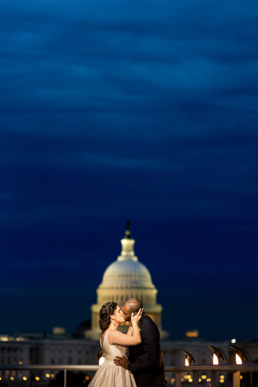 This wedding was at the Newseum in Washington DC, this was a dusk, sunset shot of the couple in front of the Capitol Building, the groom is black and the bride is white, the sky is a rich blue and the glowing dome of the Capitol Building is behind their heads, Procopio Photography, best top Washington DC photographer, best top Maryland photographer, best top Virginia photographer, best top DMV photographer, best top wedding photographer, best top commercial photographer, best top portrait photographer, best top boudoir photographer, modern fine art portraits, dramatic, unique, different, bold, editorial, photojournalism, award winning photographer, published photographer, memorable images, be different, stand out