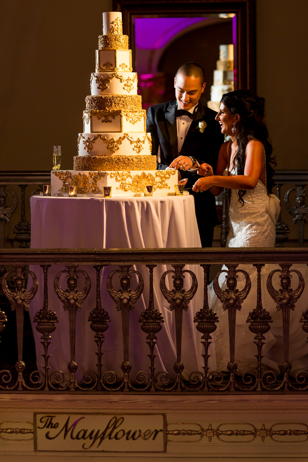 This wedding was at the Mayflower Hotel in Washington DC, The bride and groom are cutting the cake, their cake is a nine tear cake, gold and white cake, big wedding, Procopio Photography, best top Washington DC photographer, best top Maryland photographer, best top Virginia photographer, best top DMV photographer, best top wedding photographer, best top commercial photographer, best top portrait photographer, best top boudoir photographer, modern fine art portraits, dramatic, unique, different, bold, editorial, photojournalism, award winning photographer, published photographer, memorable images, be different, stand out