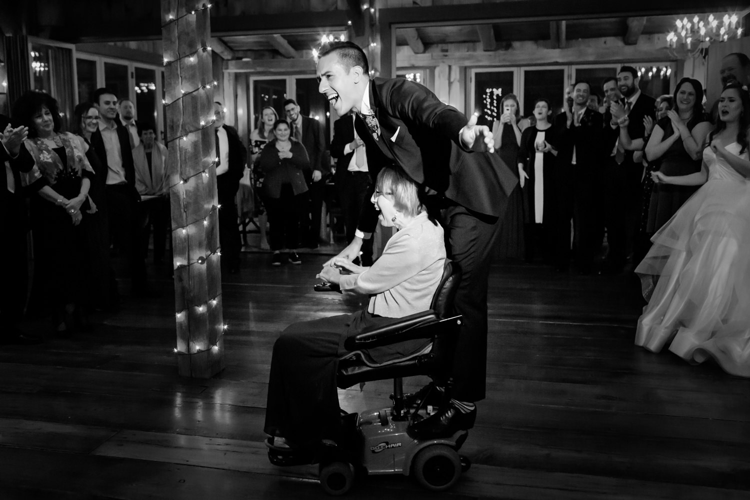 This is a Mountain Memories at Thorpewood wedding in Maryland, the mother of the groom is in a wheelchair, the groom still has his mother son dance with her and her jumps on her motorized wheelchair to spin around with her in dance, loving, beautiful moment between mother and son, Procopio Photography, best top Washington DC photographer, best top Maryland photographer, best top Virginia photographer, best top DMV photographer, best top wedding photographer, best top commercial photographer, best top portrait photographer, best top boudoir photographer, modern fine art portraits, dramatic, unique, different, bold, editorial, photojournalism, award winning photographer, published photographer, memorable images, be different, stand out