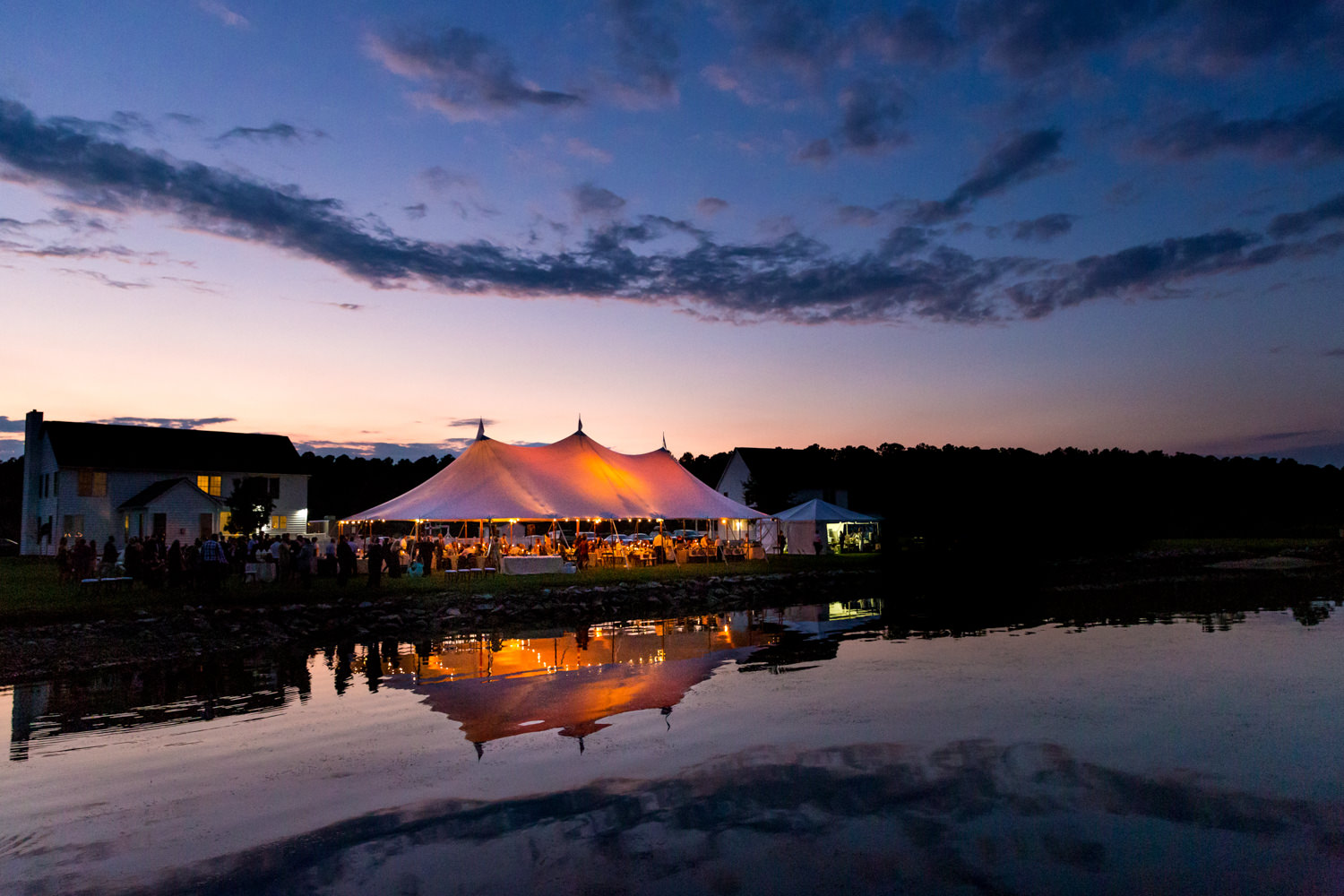 This was an Eastern Shore Maryland Wedding, Swan Cove Manor, this is a landscape shot of just the reception tent on the water, you can see the glowing tent, the blue and orange sky and the reflection of the tent in the water, Procopio Photography, best top Washington DC photographer, best top Maryland photographer, best top Virginia photographer, best top DMV photographer, best top wedding photographer, best top commercial photographer, best top portrait photographer, best top boudoir photographer, modern fine art portraits, dramatic, unique, different, bold, editorial, photojournalism, award winning photographer, published photographer, memorable images, be different, stand out