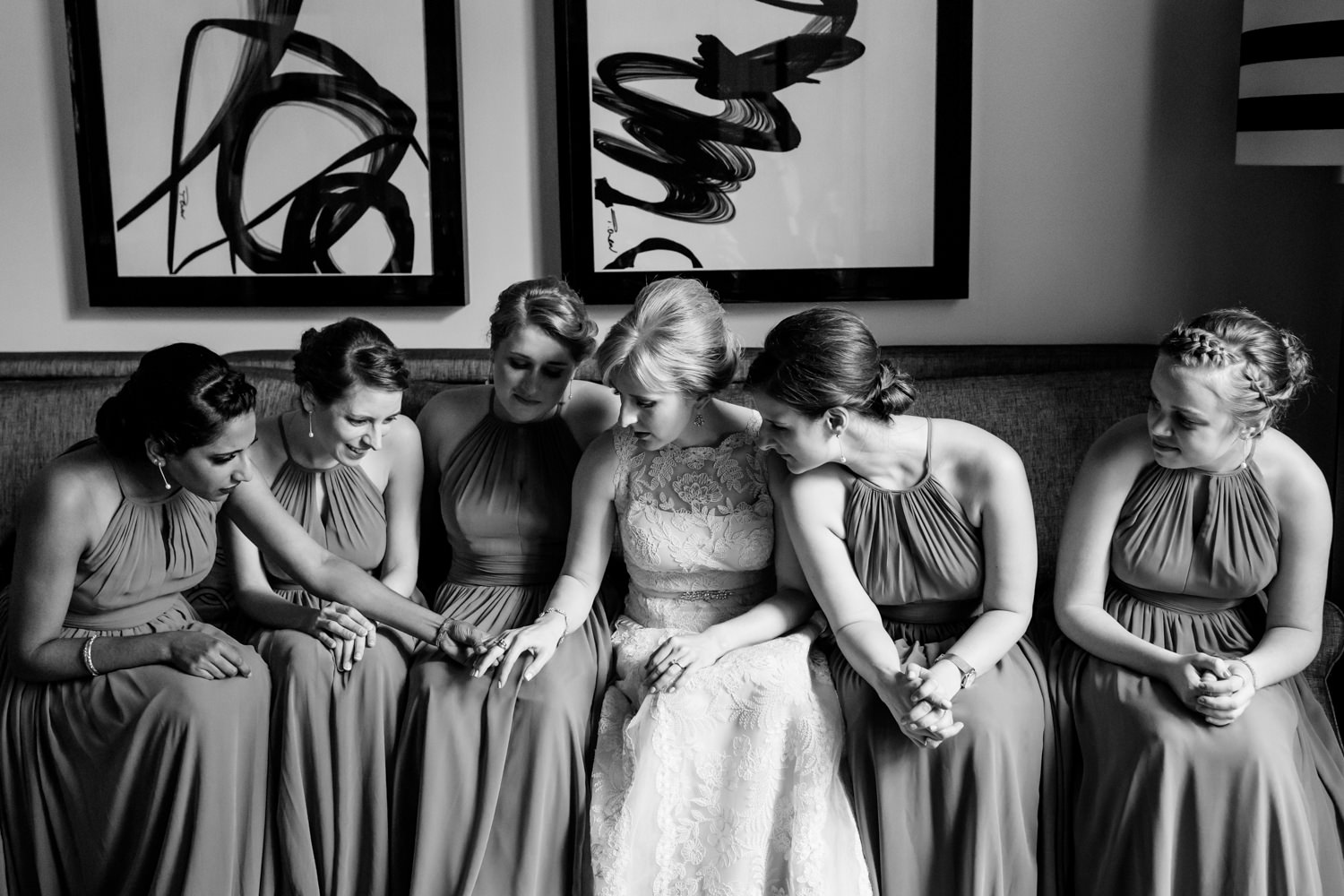 This wedding was at The hotel Monaco in Chinatown, Washington DC, the bride and her bridesmaids take a moment to sit on the couch and admire the bride's ring, this is a black and white photo, Procopio Photography, best top Washington DC photographer, best top Maryland photographer, best top Virginia photographer, best top DMV photographer, best top wedding photographer, best top commercial photographer, best top portrait photographer, best top boudoir photographer, modern fine art portraits, dramatic, unique, different, bold, editorial, photojournalism, award winning photographer, published photographer, memorable images, be different, stand out