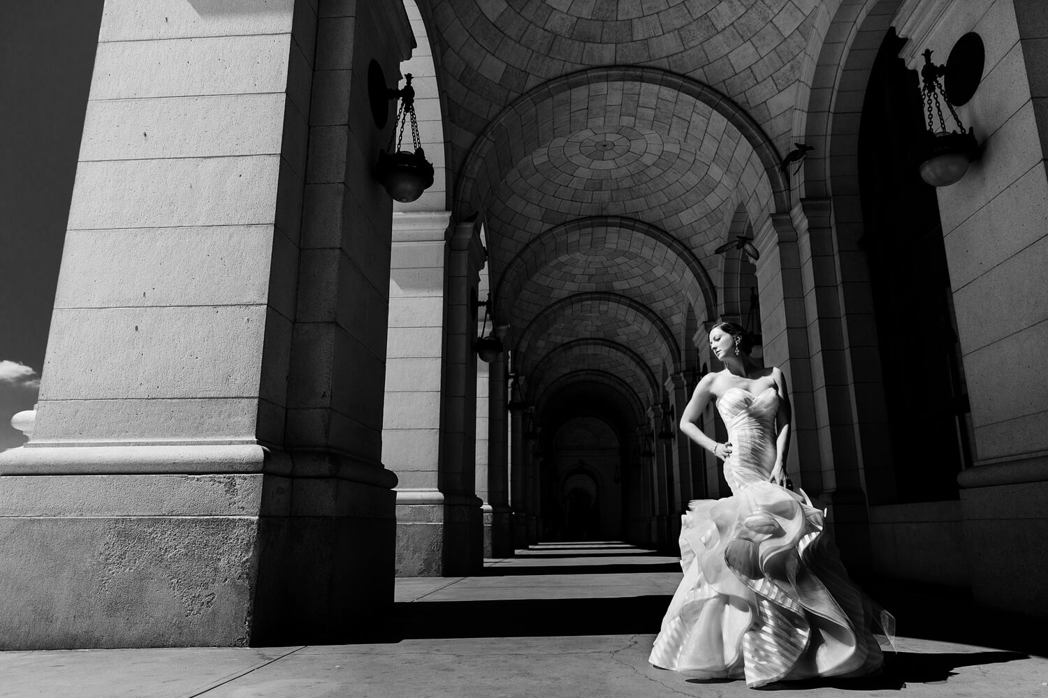 This bridal portrait was taken under the union market arches, This is a commonly photographed area but we took it to the next level, lighting the bride with the sun and having her stand in an editorial pose, She looks strong and beautiful, This is a dramatic black and white photo, Procopio Photography, best top Washington DC photographer, best top Maryland photographer, best top Virginia photographer, best top DMV photographer, best top wedding photographer, best top commercial photographer, best top portrait photographer, best top boudoir photographer, modern fine art portraits, dramatic, unique, different, bold, editorial, photojournalism, award winning photographer, published photographer, memorable images, be different, stand out