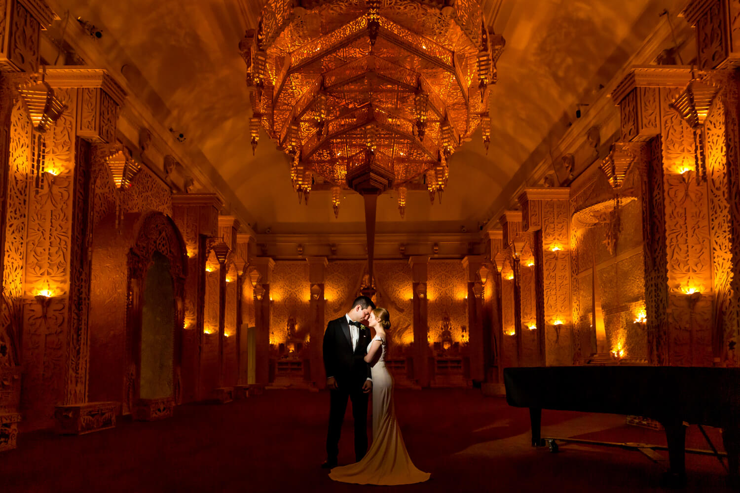 portrait of couple in a wood temple with gold lighting in the renwick gallery of art museum in DC david best burning man