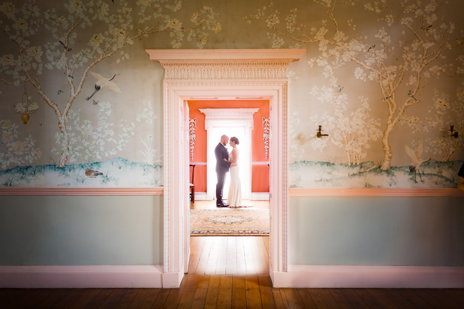 Procopio Photography, best top Washington DC photographer photography, best top Maryland photographer photography, best top Virginia photographer photography, best top DMV photographer photography, best top commercial photographer photography, best top wedding photographer photography, best top portrait photographer photography, best top boudoir photographer photography, modern fine art portraits, dramatic, unique, different, bold, editorial, photojournalism, award winning photographer, published photographer, memorable images, be different, stand out, luxe wedding, luxury wedding, luxury portraits, luxury boudoir, bespoke, Whitehall Annapolis Maryland Wedding, portraits in a historic house, vintage wallpaper, salmon pink and dusty blue interior colors on a historic home, waterfront wedding, Jewish Wedding, the bride and groom are standing in a backlit doorway showing the architecture architectural elements in the room